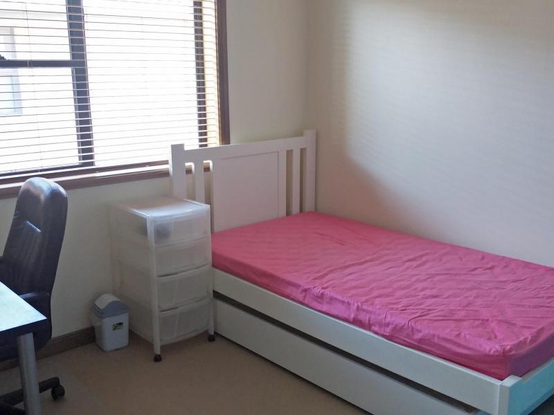 Room with bed, study desk, chair and a cupboard. Also include 4 large wardrobe for other items